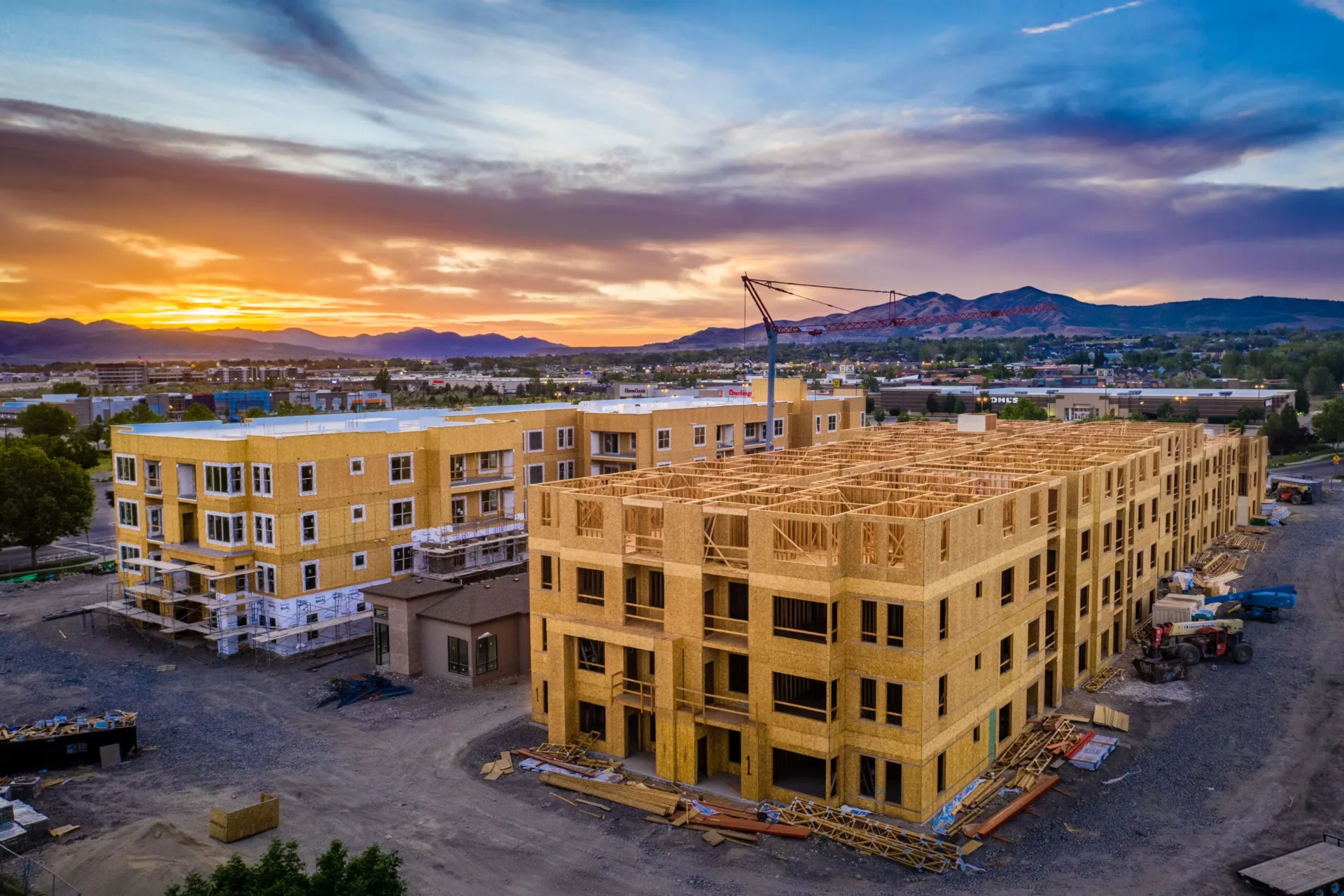 Multifamily apartment community under exterior restoration at sunset