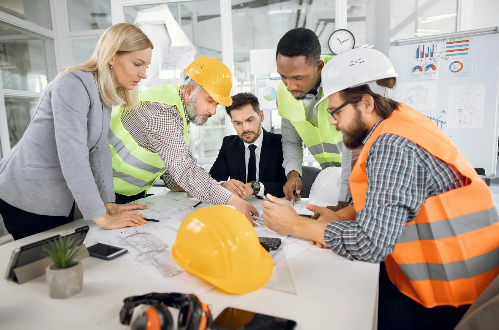 Cap Ex project team reviewing plans with a property manager in a site meeting