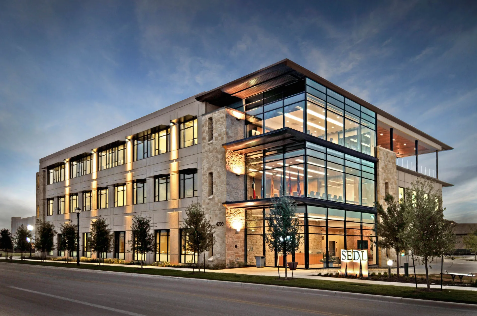 Restored exterior of a community clubhouse and common area building at dusk