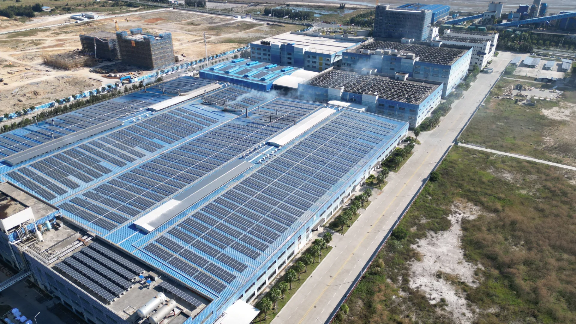 Aerial view of a large industrial roof undergoing a capital improvement project