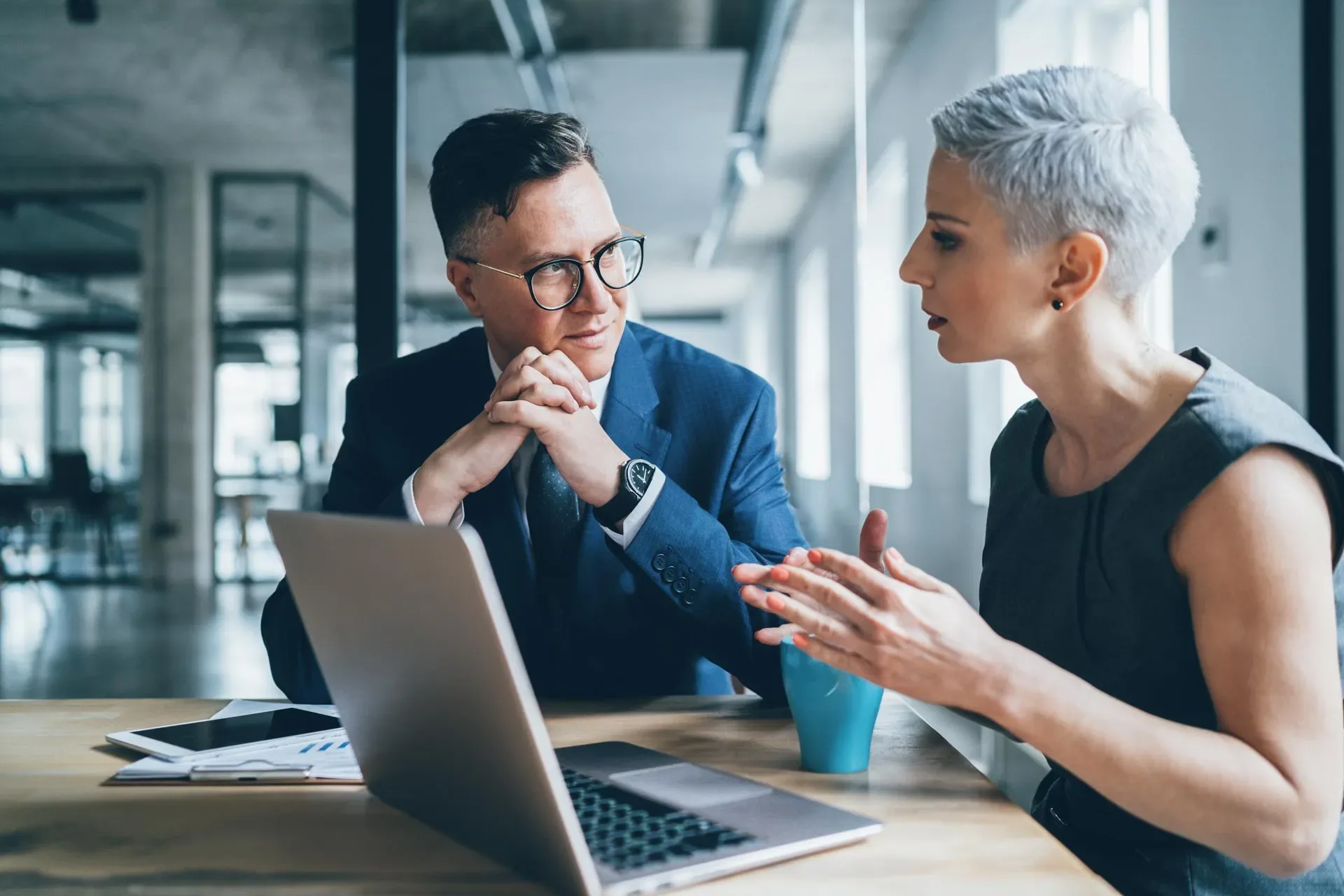 Two professionals reviewing a commercial construction project plan